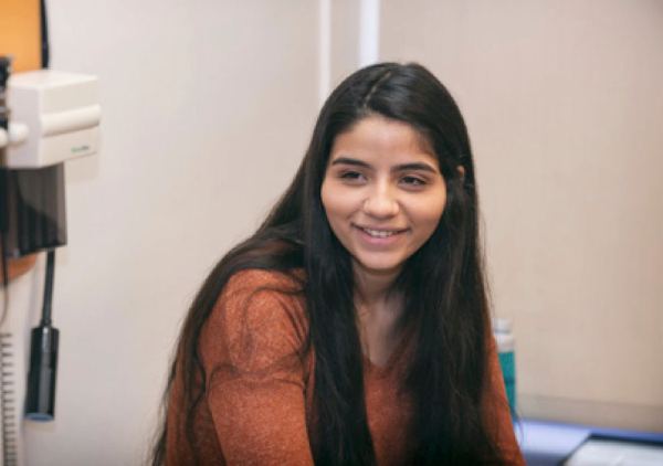 Smiling teen girl in exam room