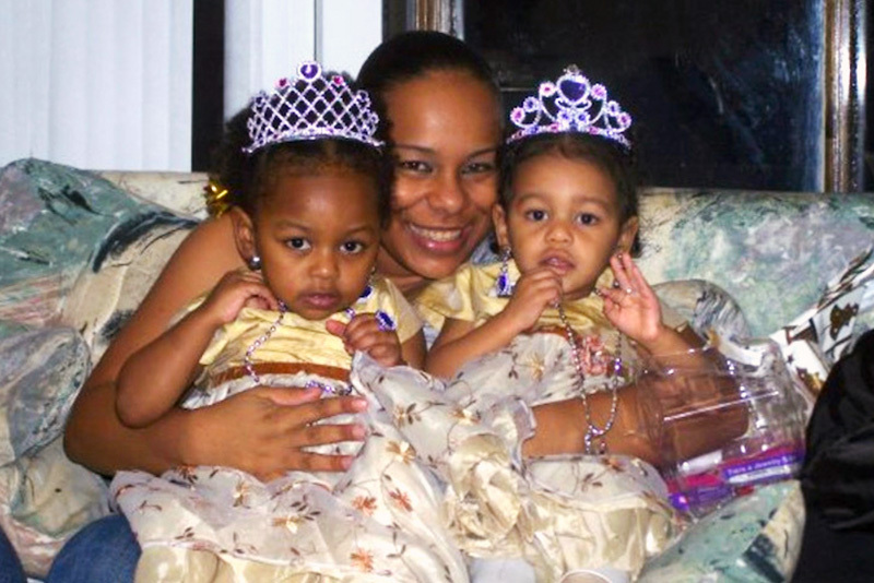 Alicia holds young Gwen, who has asthma, and Gricelda, who are wearing princess gowns and tiaras.