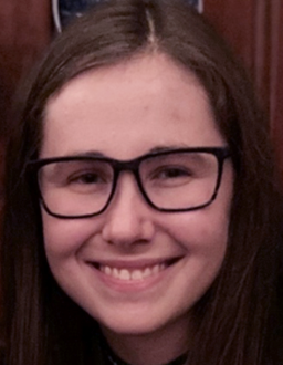a girl with glasses smiling