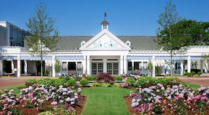 white sea crest beach hotel building with green lawn