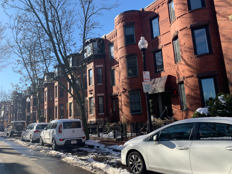 Brownstones and cars on city street