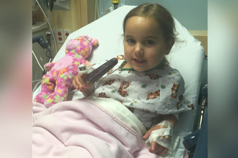 Girl lay in hospital bed after surgery