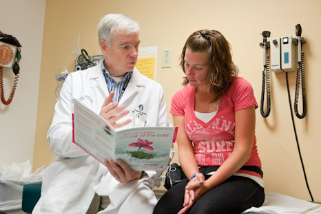 Doctor talks with young female patient